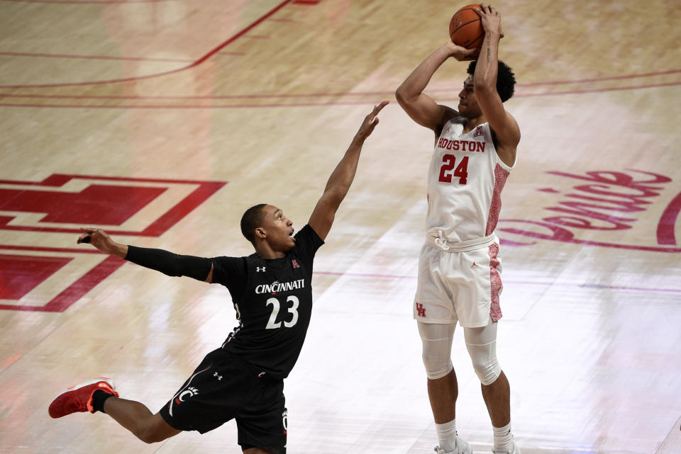Houston guard Quentin Grimes (24) shoots a 3-point basket as Cincinnati guard Mika Adams-Woods defends during the second half of an NCAA college basketball game, Sunday, Feb. 21, 2021, in Houston. (AP Photo/Eric Christian Smith)