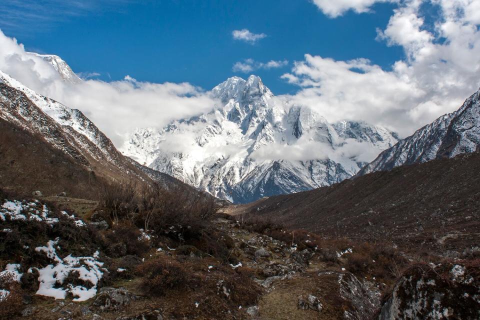 View of the mountains near the village of Bimthang on the Manaslu Circuit, 12 days from the trailhead at Arughat Bazaar. The 16-day Manaslu Circuit is part of the Great Himalaya Trail (GHT), a series of trekking trails developed by Dutch aid agency, SNV, together with the Nepalese government, which crosses Nepal from East to West and when finished aims to cover 8000 kilometres across the Himalayas. Around 85% of trekkers to Nepal - approximately 100,000 people per year walk in the country's three most established areas- Annapurna, Everest and Langtang. Around 45% of people living in Nepals mountains live below the poverty line. The GHT hopes that by opening new walking trails tourism can become a tool for poverty alleviation.