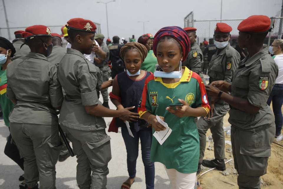 Gendarmerie search Cameroon soccer fans outside the stadium before the African Cup of Nations 2022 quarterfinal match between Gambia and Cameroon at Japoma Stadium, Douala, Cameroon, Saturday, Jan. 29, 2022. (AP Photo/Sunday Alamba)