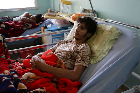 Pro-government soldiers lie in hospital beds while being treatment for injuries they sustained in fighting against Houthis, in the northern city of Marib, Yemen November 4, 2017. REUTERS/Ali Owidha