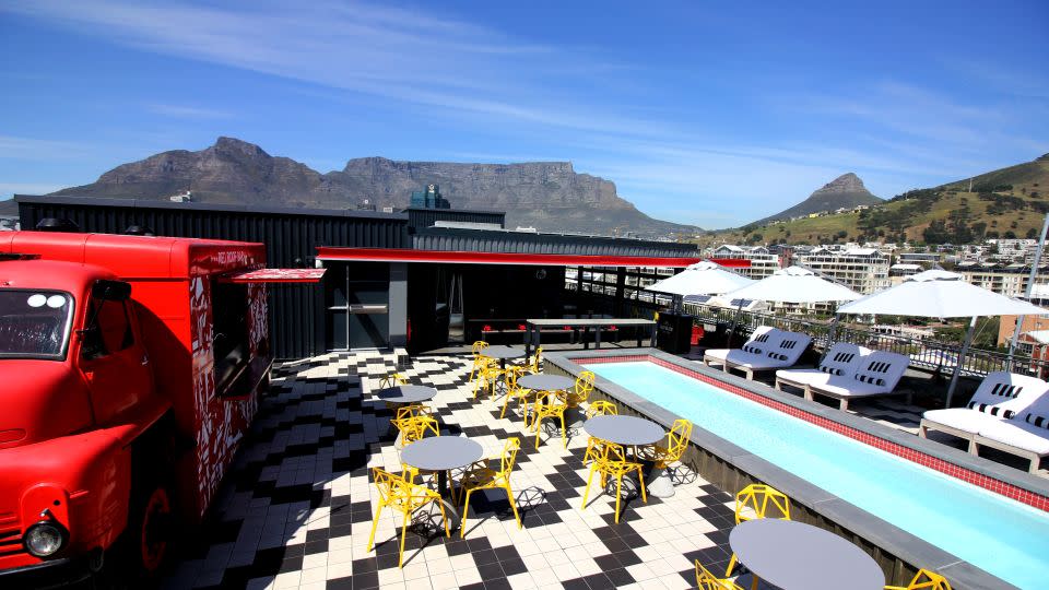 In addition to community projects, Mpahlwa's team also designs commercial properties, including the Radisson RED hotel in Cape Town. Pictured: the view from the rooftop pool at the hotel, with Table Mountain in the background. - Radisson RED Cape Town, V&A Waterfront