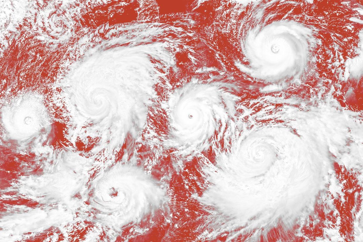 An illustration of a weather map with lots of hurricanes on it. 
