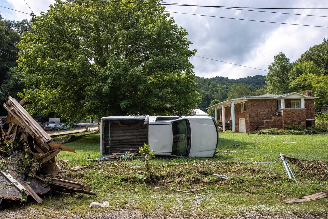 A wrecked truck rests on its side July 28, 2022 in front of a house in Hindman, Ky. from flood damage that ravaged Eastern Kentucky.