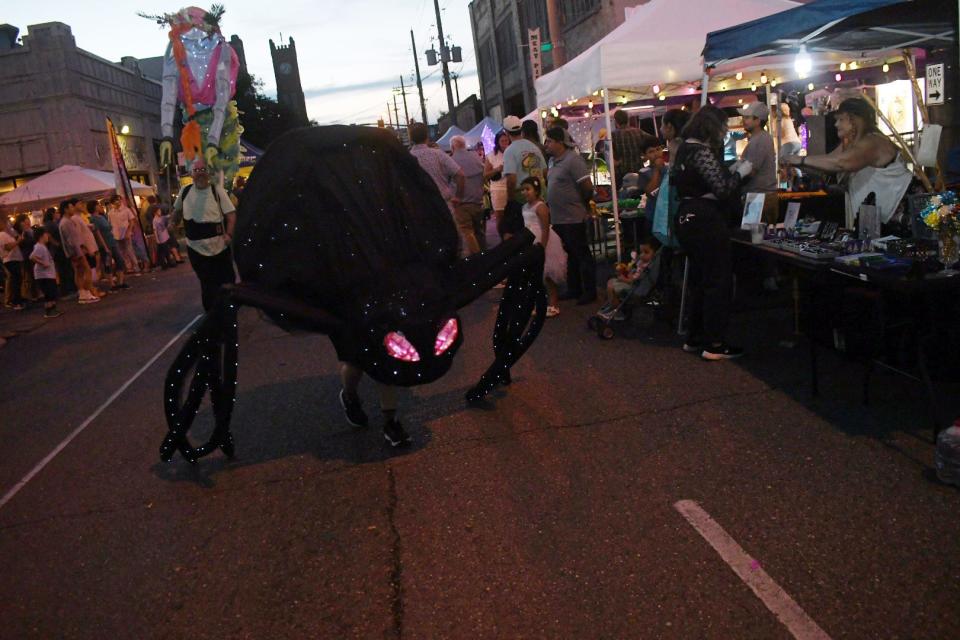 A giant spider with glowing red eyes was one of the lighted figures in the Alexandria Museum of Art Luminary Procession that marched through the streets of downtown Alexandria Friday. The procession was part of Alexandria River Fete.