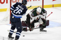 Arizona Coyotes' Ilya Lyubushkin (46) blocks a shot by Winnipeg Jets' Blake Wheeler (26) during the first period of NHL hockey game action in Winnipeg, Manitoba, Monday, Nov. 29, 2021. (Fred Greenslade/The Canadian Press via AP)