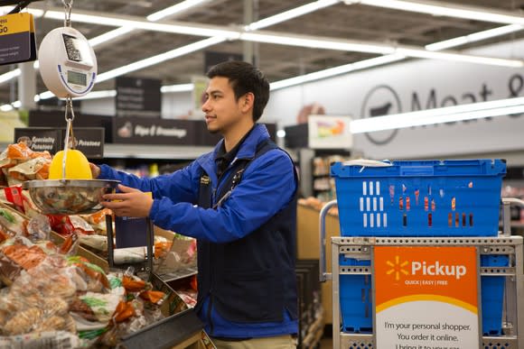 A Walmart associate weighing produce.