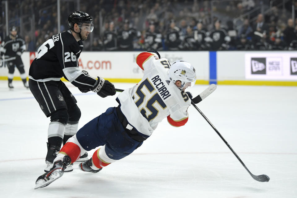 Florida Panthers center Noel Acciari, right, falls as he shoots the puck while under pressure from Los Angeles Kings defenseman Sean Walker during the first period of an NHL hockey game Thursday, Feb. 20, 2020, in Los Angeles. (AP Photo/Mark J. Terrill)