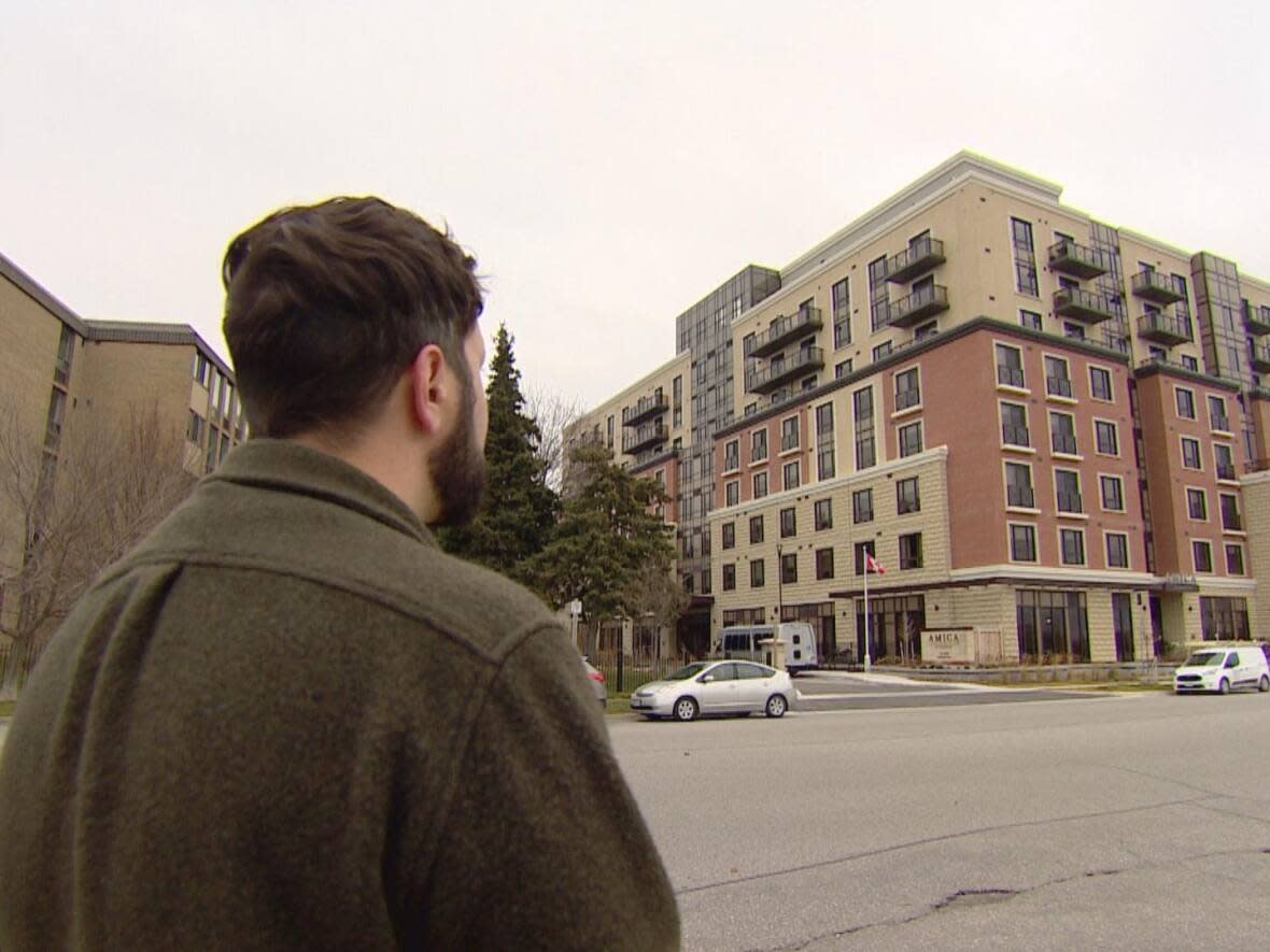 David Panepinto is shown here looking at the retirement community his brother Chris helped build in Pickering, Ont. Chris died when he was crushed by a temporary barrier. (Paul Borkwood/CBC - image credit)