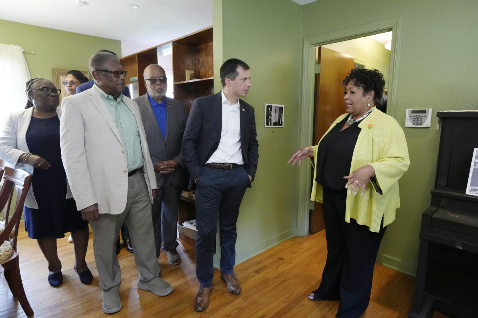 U.S. Transportation Secretary Pete Buttigieg, second from right, U.S. Rep. Bennie Thompson, D-Miss., second from left, and Mississippi Transportation Commissioner for the Central District Willie Simmons, left, listen as Reena Evers-Everette, speaks about her life as a young child in the home of assassinated civil rights leader Medgar Evers, Friday, June 21, 2024, in Jackson, Miss. The house, the Medgar and Myrlie Evers National Monument, was one of the stops Buttigieg made as he spent Thursday and Friday in Mississippi, promoting projects that will be helped or will be receiving money from a federal infrastructure act. (AP Photo/Rogelio V. Solis, Pool)