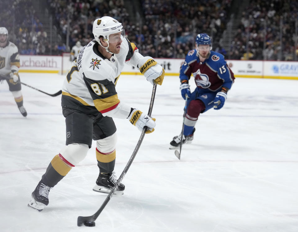 Vegas Golden Knights right wing Jonathan Marchessault, front, puts a shot on the net as Colorado Avalanche right wing Valeri Nichushkin defends during the second period of an NHL hockey game Wednesday, Jan. 10, 2024, in Denver. (AP Photo/David Zalubowski)
