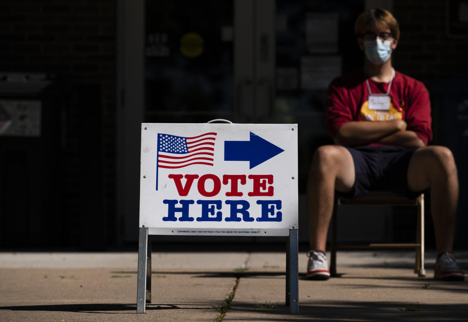 A "vote here" sign.