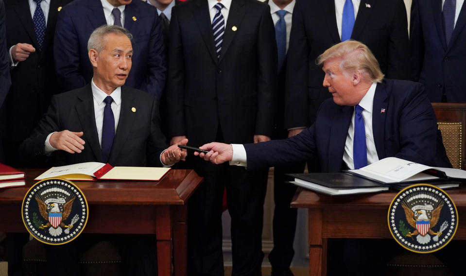 Chinese Vice Premier Liu He is handed a pen by U.S. President Donald Trump after signing "phase one" of the U.S.-China trade agreement during a ceremony in the East Room of the White House in Washington, U.S., January 15, 2020. REUTERS/Kevin Lamarque