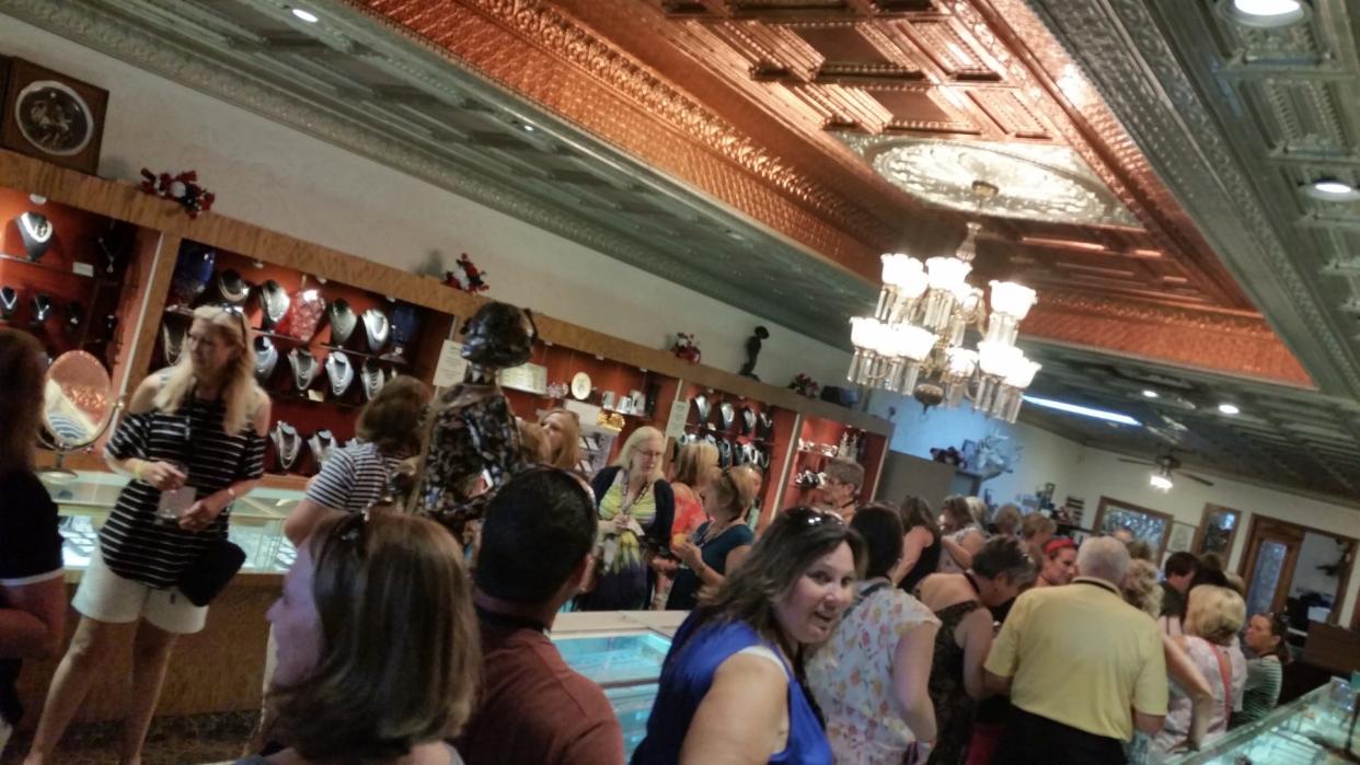 2022 Wine Crawl participants are shown inside Frenchie's Fine Jewelry on East Front Street. This year's Wine Crawl is July 21. Tickets are still available.