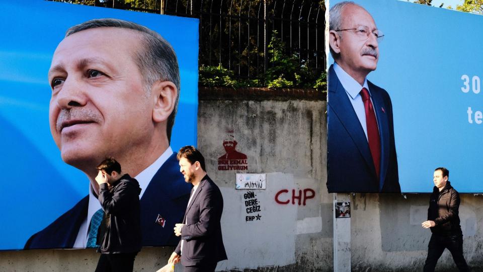 People in Istanbul, Turkey, on May 2, 2023, are passing by a photo of opposition Republican People&#39;s Party (CHP) leader Kemal Kilicdaroglu and Turkish President Recep Tayyip Erdogan as general elections are set to be held in Turkey on May 14, 2023 to elect the President of Turkey and to elect the parliamentary elections.