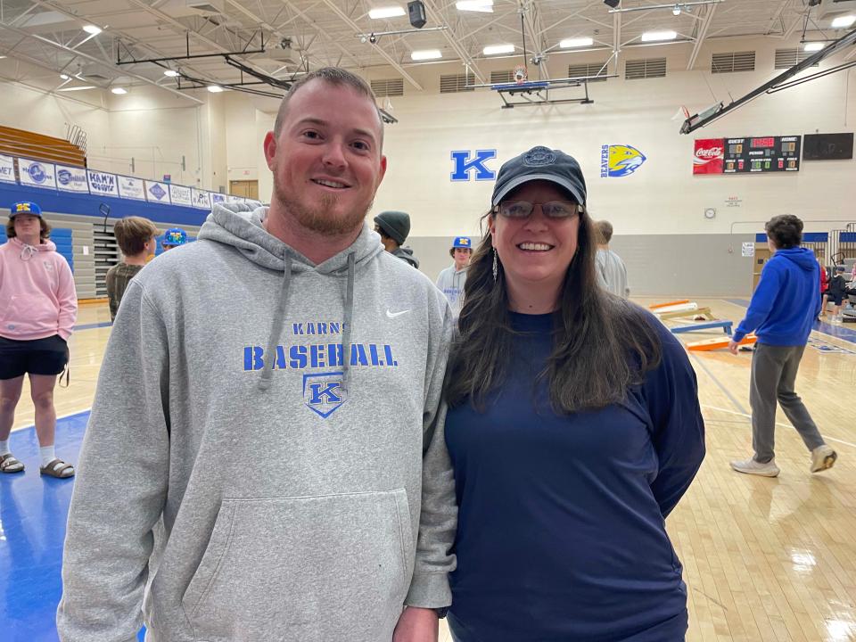 Karns head baseball coach Drew Patterson gets support from principal Laicee Hatfield at a cornhole tournament fundraiser at the high school Dec. 17, 2023.