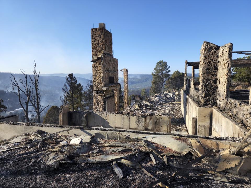 The remains of a home left after a wildfire spread through the Village of Ruidoso, N.M. on Wednesday, April 13, 2022. Officials say a wildfire has burned about 150 structures, including homes, in the New Mexico town of Ruidoso. (Alexander Meditz via AP)