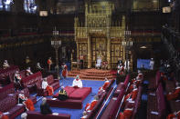 Britain's Queen Elizabeth II delivers a speech from the throne in the House of Lords during the State Opening of Parliament in the House of Lords at the Palace of Westminster in London, Tuesday May 11, 2021. (Eddie Mulholland/Pool via AP)