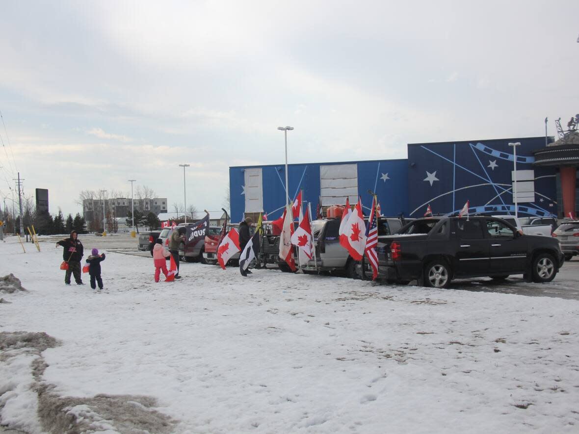 On Sunday, protestors gathered at the closed SilverCity movie theatre at the Mikhail Centre in Windsor to commemorate the one-year anniversary of the blockade which closed the Ambassador Bridge for six days. (Mike Evans/CBC - image credit)