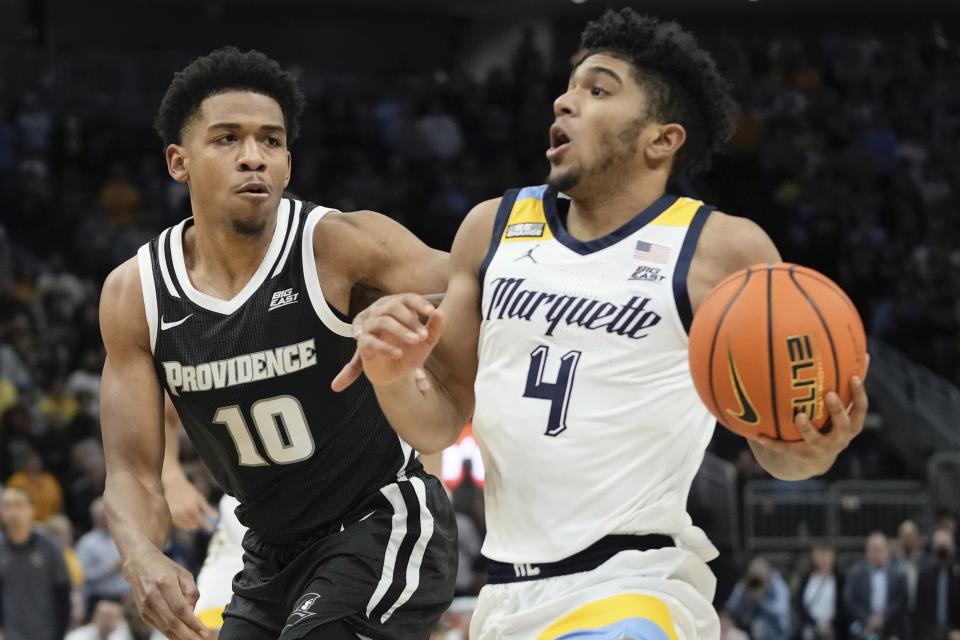 Marquette's Stevie Mitchell drives past Providence's Noah Locke during the first half of an NCAA college basketball game Wednesday, Jan. 18, 2023, in Milwaukee. (AP Photo/Morry Gash)