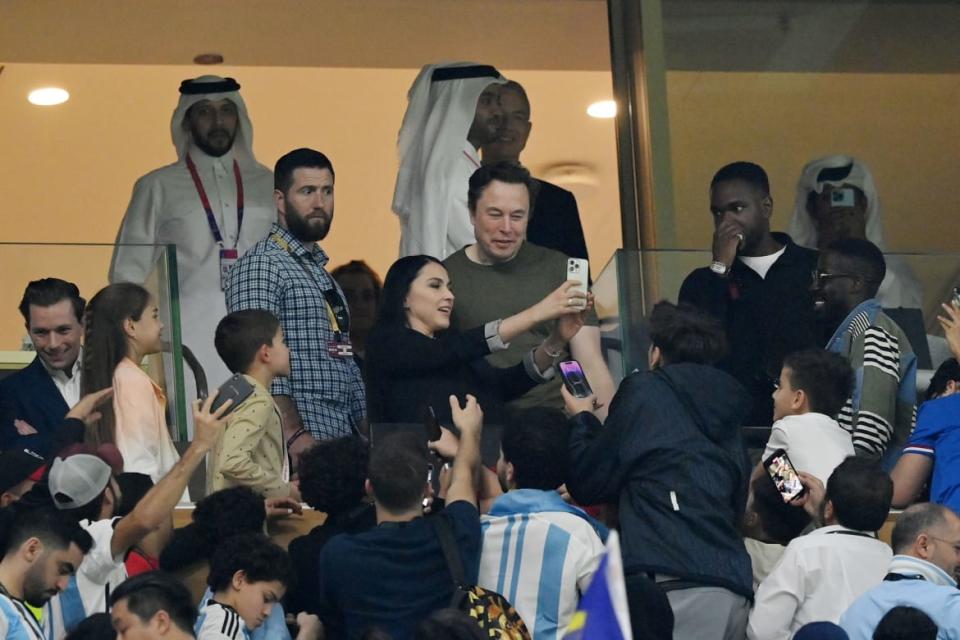 <div class="inline-image__caption"><p>Fans take photos with Elon Musk during the FIFA World Cup Qatar 2022 Final match between Argentina and France at Lusail Stadium on Dec. 18, 2022, in Lusail City, Qatar.</p></div> <div class="inline-image__credit">Dan Mullan/Getty</div>