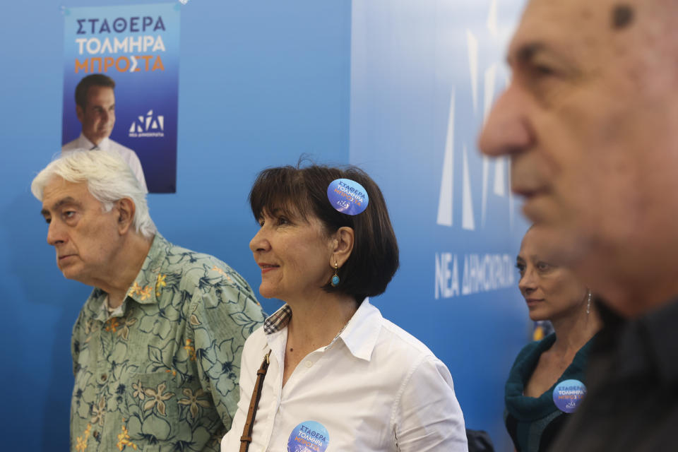 Supporters of Greece's Prime Minister and leader of New Democracy Kyriakos Mitsotakis watch the exit polls at the main polling kiosk of their party at Syntagma square, in central Athens, Greece, Sunday, May 21, 2023. Prime Minister Kyriakos Mitsotakis and his conservative party are leading Greece's election by a wide margin, according to partial official results, but a new electoral law means he will be unable to form a government without seeking coalition partners, and a second election is likely. (AP Photo/Yorgos Karahalis)