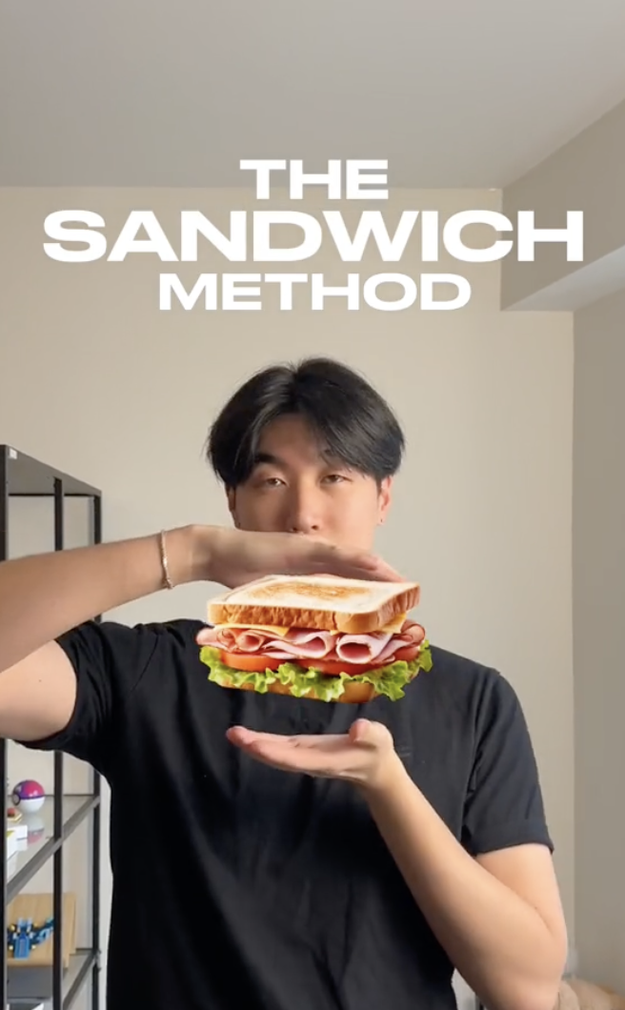 Person demonstrating 'The Sandwich Method' by holding hands apart as if holding a sandwich