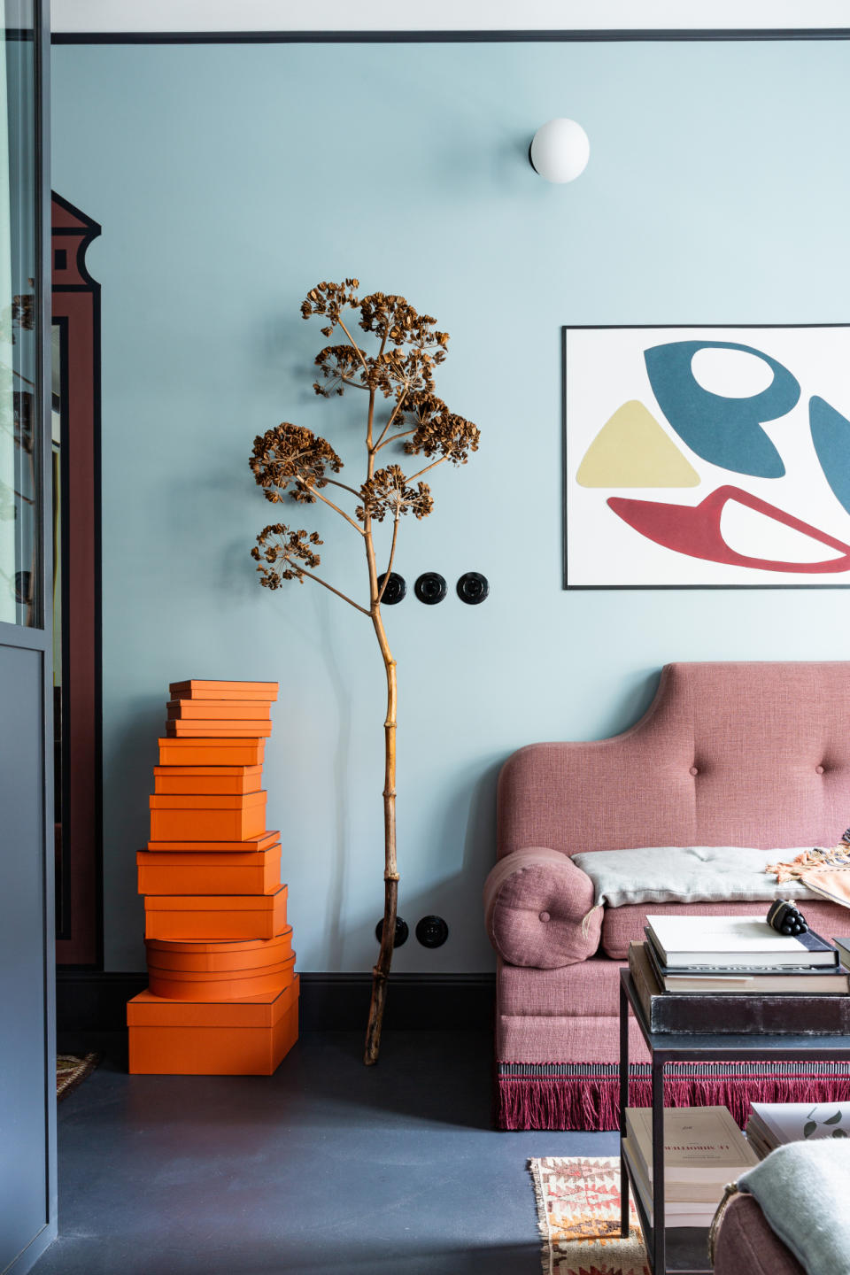 Living room with pale blue walls and burgundy trim