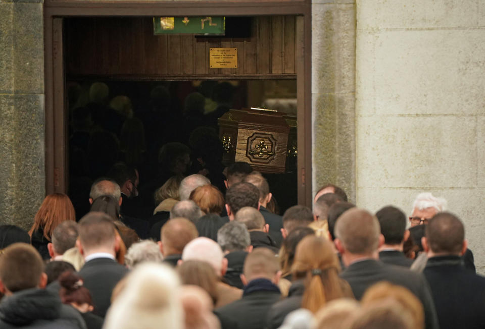 Crowds watch as Ashling Muprhy's coffin enters St Brigid's Church, Mountbolus, Co Offaly, for the funeral of the schoolteacher who was murdered in Tullamore, Co Offaly last Wedensday. 23-year-old Ashling was found dead after going for a run on the banks of the Grand Canal in Tullamore.. Picture date: Tuesday January 18, 2022.