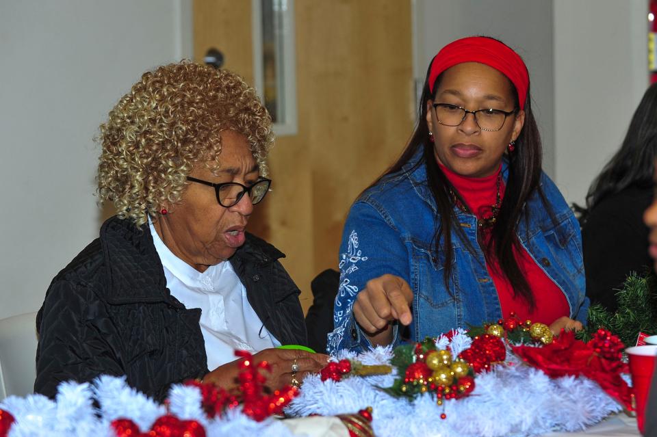 Cherry McMahon and Wanda Wollo talk at the 8th annual holiday wreath-making for families who have lost children and loved ones to gun violence. The families gathered at the Knoxville Public Works Building earlier this month. McMahon and Wollo honored Aisha Cataes with their wreath.