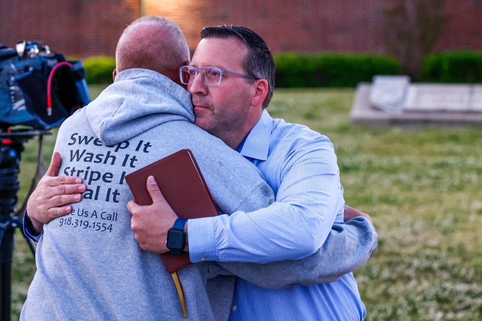 Pastor Ryan Wells hugs Nathan Brewer, the father of Brittany Brewer who was found dead, after a vigil in Henryetta Okla., on Monday, May 1, 2023.