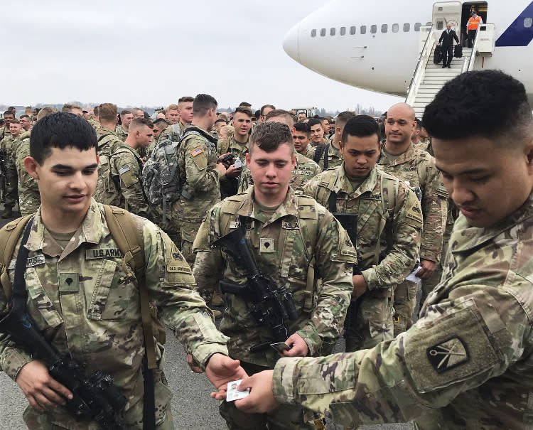 Soldiers from the 1st Armored Division, based in Fort Bliss, Texas, arrives at the airport Tegel in Berlin, Thursday, March 21, 2019. Over three hundred soldiers have arrived in Germany from their base in Texas in the first test of a new American strategy to rapidly deploy troops based in the United States to Europe to bolster the NATO deterrent against possible Russian aggression. (AP Photo/Dorothee Thiesing)