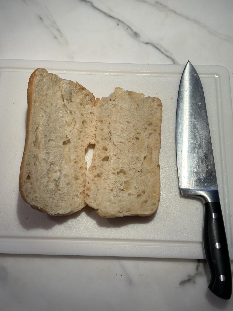 The sliced bread on a cutting board next to a knife