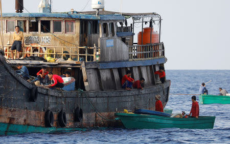 Chinese fishermen rest at a fishing vessel at the disputed Scarborough Shoal April 6, 2017. Picture taken April 6, 2017 REUTERS/Erik De Castro