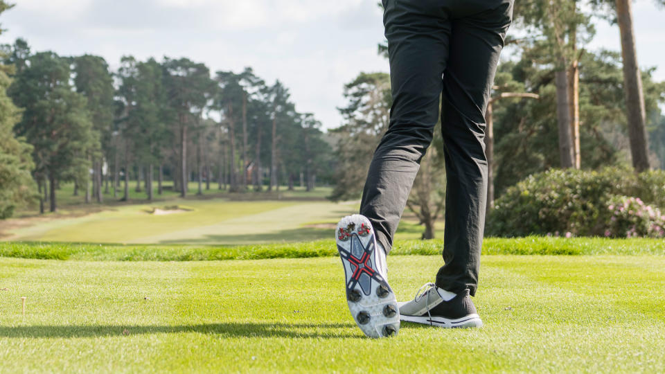 Dan Parker hitting a golf shot with a view of the Payntr X 004 RS outsole on the golf course