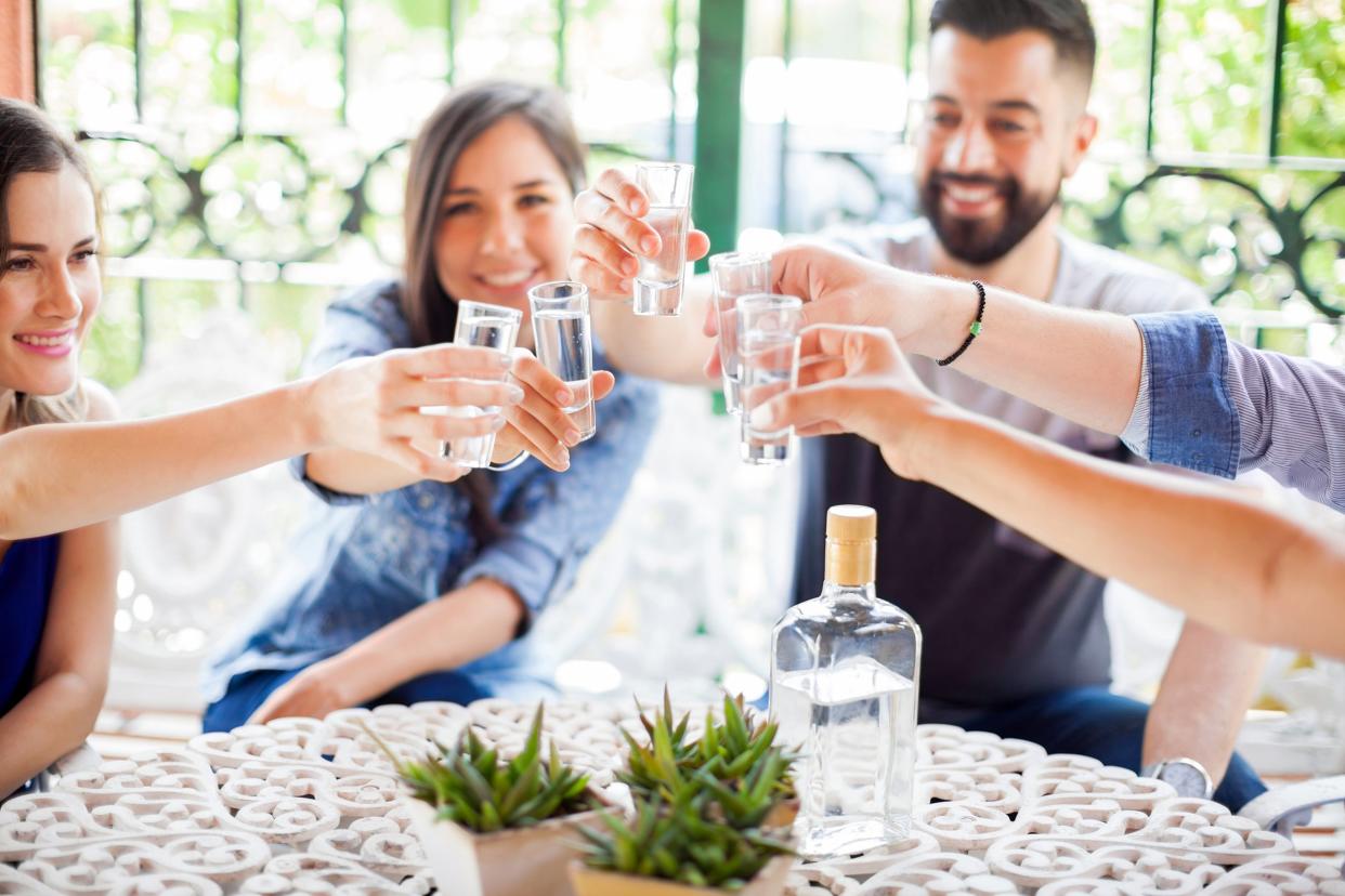 Group of friends toasting their tequila