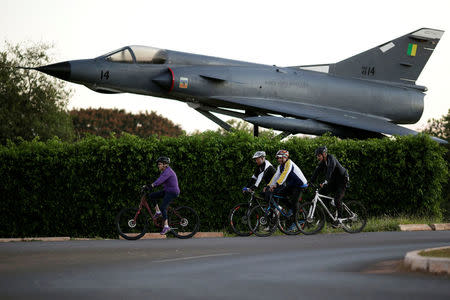 Brazil's President Dilma Rousseff rides her bicycle accompanied by bodyguards near the Alvorada Palace in Brasilia, Brazil April 15, 2016. REUTERS/Ueslei Marcelino