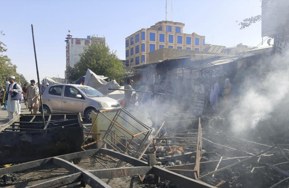 Smoke rises from damaged shops after fighting between Taliban and Afghan security forces in Kunduz city, northern Afghanistan, Sunday, Aug. 8, 2021. Taliban fighters Sunday took control of much of the capital of Kunduz province, including the governor's office and police headquarters, a provincial council member said. (AP Photo/Abdullah Sahil)