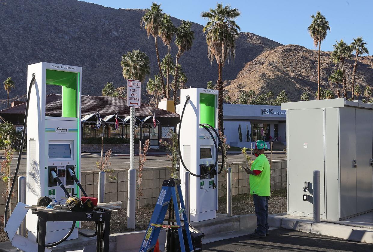 Francisco Diaz installs an electric vehicle charging station in downtown Palm Springs in 2020.