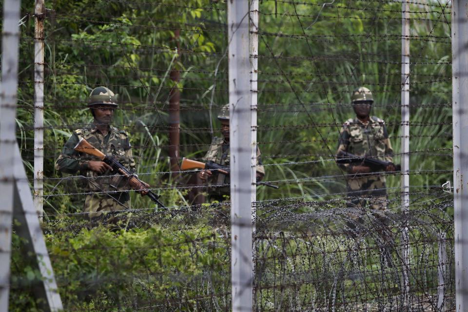 In this Tuesday, Aug. 13, 2019 file photo, India's Border Security Force (BSF) soldiers patrol near the India Pakistan border fencing at Garkhal in Akhnoor, about 35 kilometers (22 miles) west of Jammu, India. Pakistan's prime minister assured Kashmiri people living in the Indian-administered part of the divided region that he supports them in their struggle for self-determination. In his statement Wednesday, Imran Khan condemned New Delhi's decision Aug. 5 to downgrade Kashmir's status, as he began celebrations marking Pakistan's independence day.(AP Photo/Channi Anand)