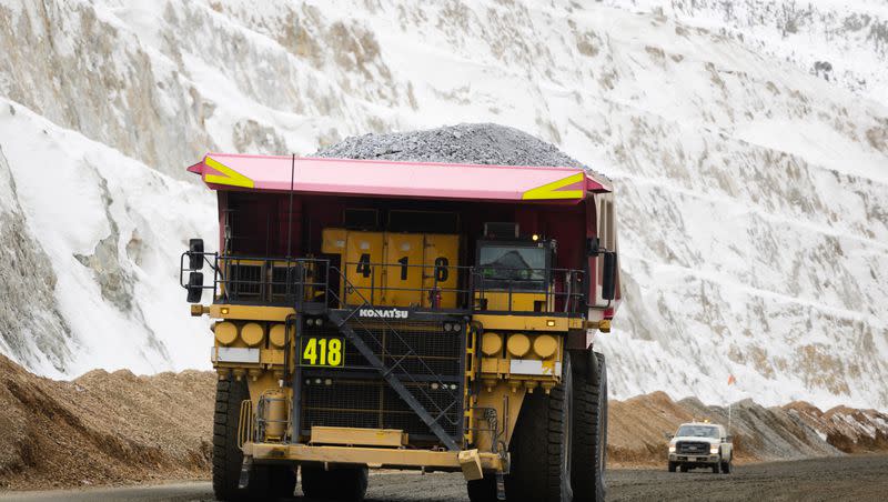 A haul truck looms over a crew truck with a full load of copper ore waste at the Rio Tinto Kennecott Copper Mine in Herriman on Monday, Feb. 20, 2023.