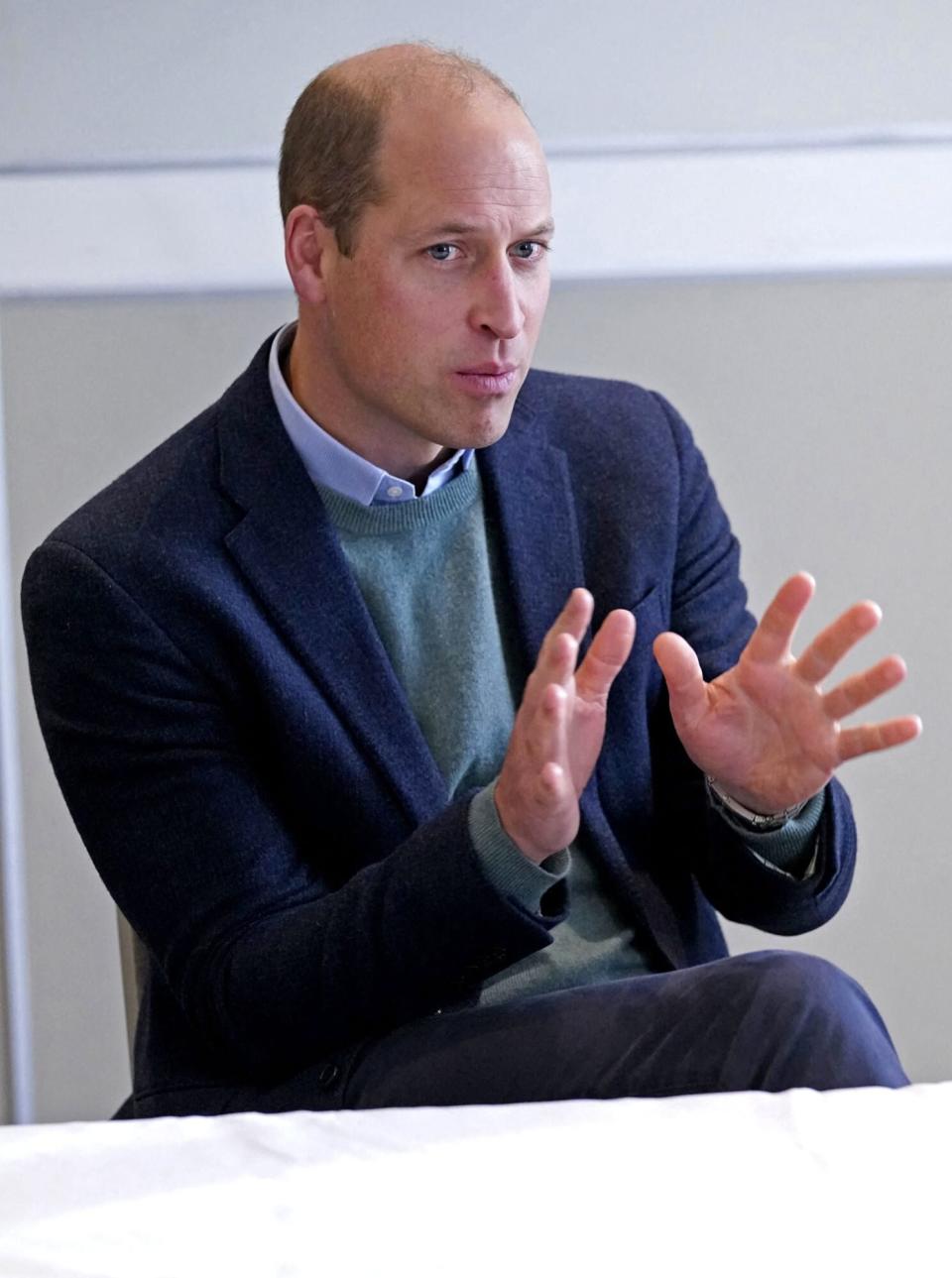 Prince William, Duke of Cambridge talks with refugees evacuated from Afghanistan during a visit to a hotel in Leeds