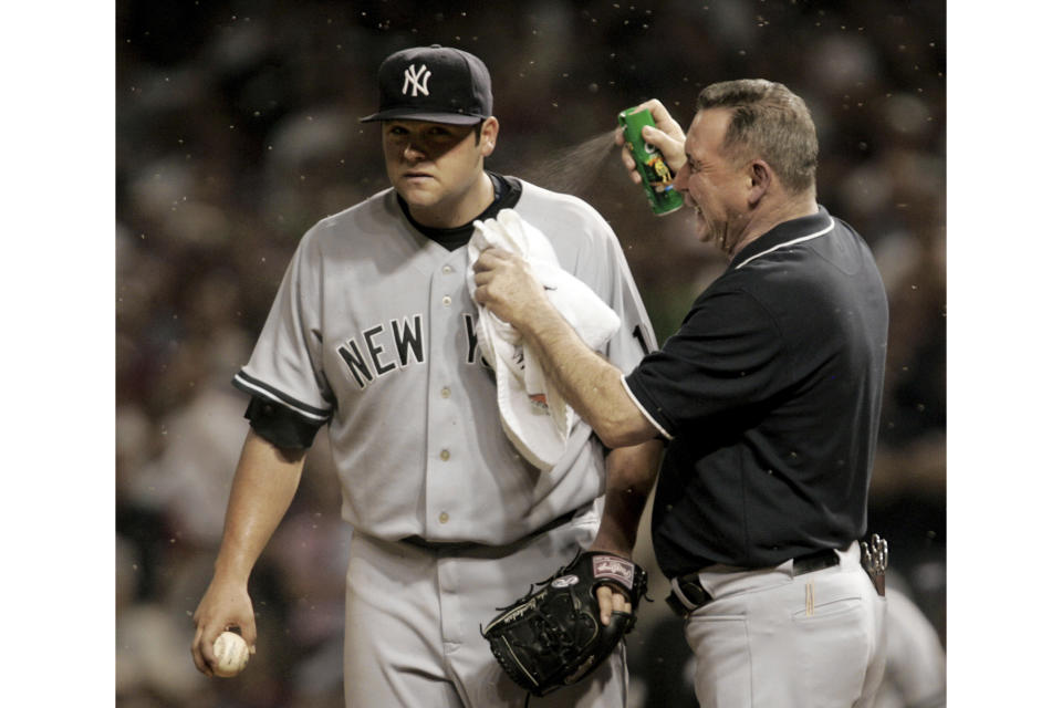 FILE - New York Yankee head trainer Gene Monahan sprays New York Yankees pitcher Joba Chamberlain with bug spray as small insects swarm in the eighth inning of Game 2 of an American League Division Series baseball game against the Cleveland Indians, Friday, Oct. 5, 2007, in Cleveland. Their fans still bugged by what happened in 2007, the New York Yankees could face those pesky midges again when the American League Division Series returns to Cleveland this weekend. (AP Photo/Amy Sancetta, File)