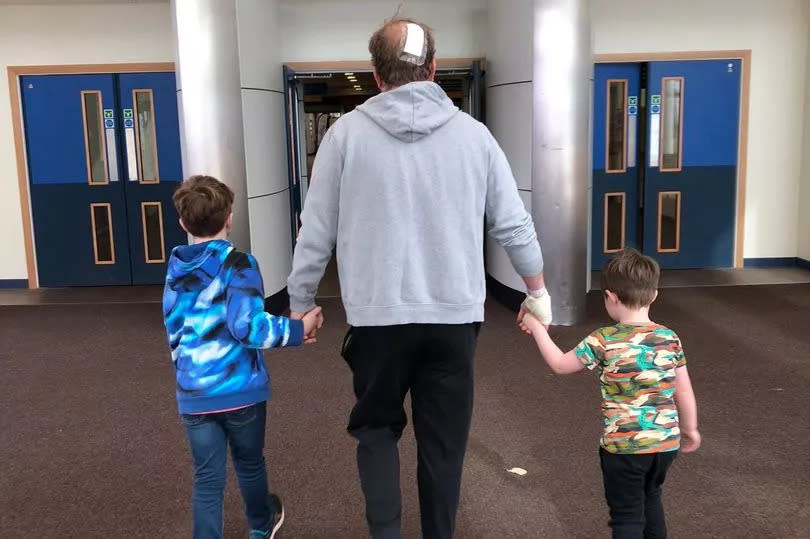 The dad walked out of the Edinburgh hospital with kids Joey, nine, and Jed, four.