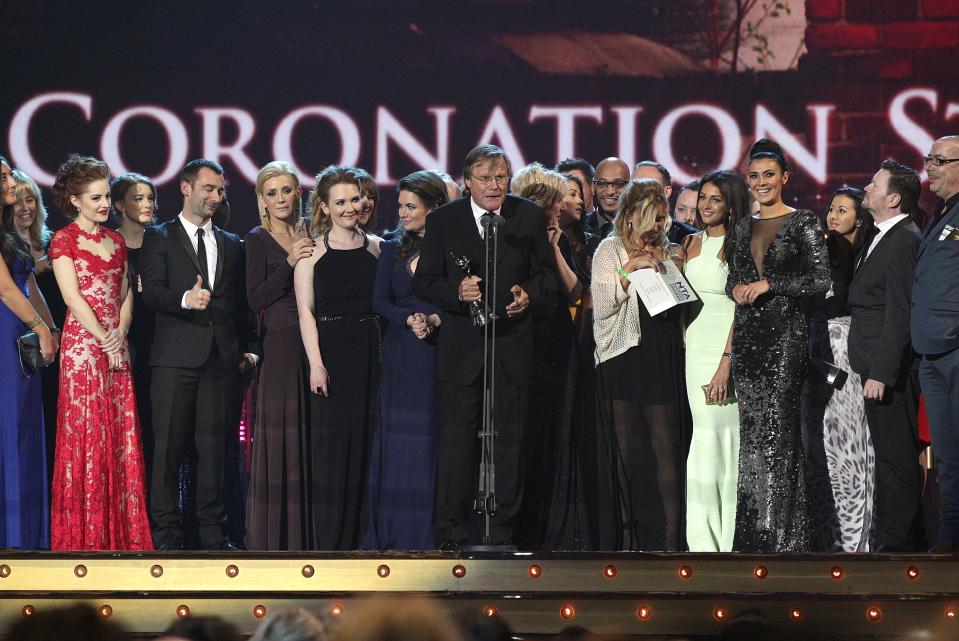 The cast and crew of Coronation Street accept the award for Best Serial Drama on stage during the 2014 National Television Awards at the O2 Arena, London.   (Photo by Yui Mok/PA Images via Getty Images)