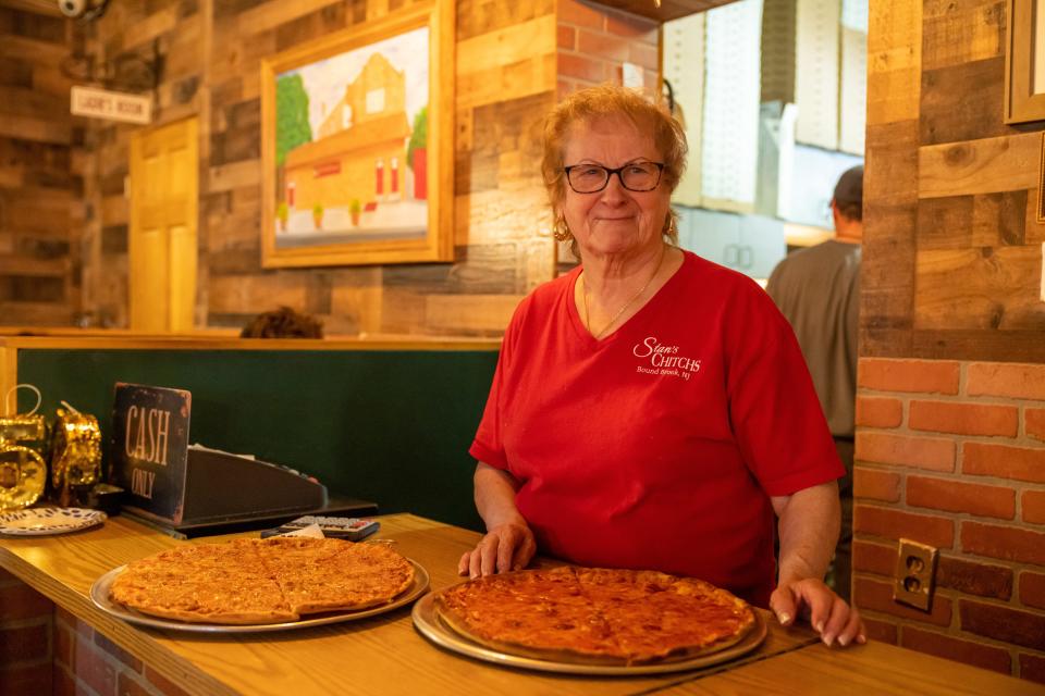 Myra Kurkowski serves pizza Wednesday at Stan's Chitch's Café that will close Saturday after 86 years in business.