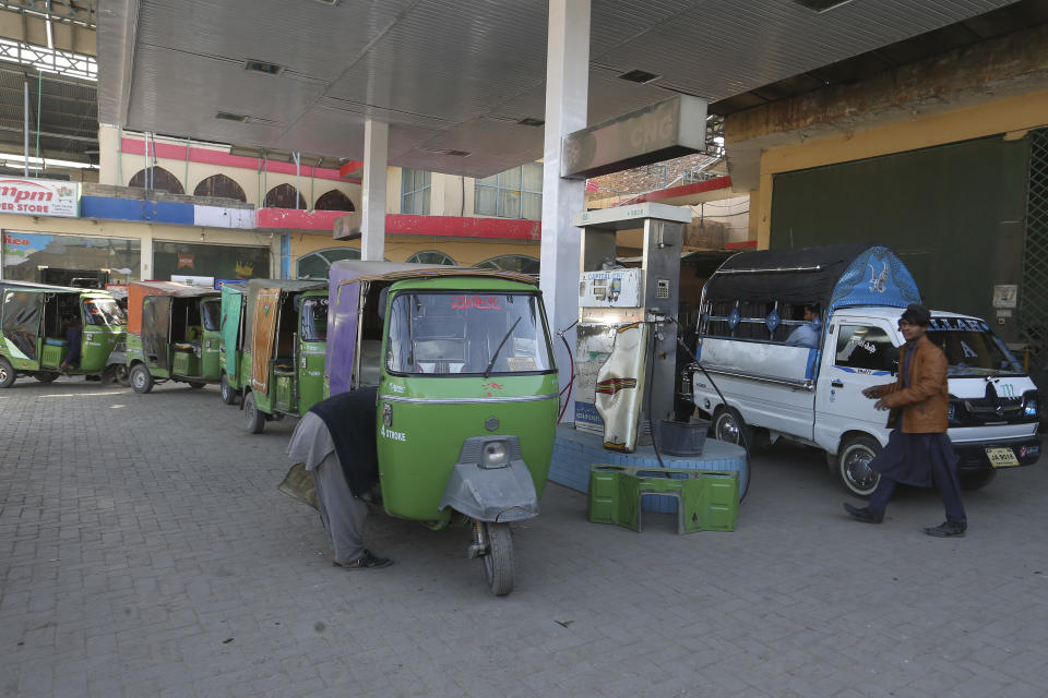 People wait their turn for filling gas into their vehicles gas at a CNG station, in Peshawar, Pakistan, Tuesday, Feb. 14, 2023. Cash-strapped Pakistan nearly doubled natural gas taxes Tuesday in an effort to comply with a long-stalled financial bailout, raising concerns about the hardship that could be passed on to consumers in the impoverished south Asian country. Pakistan's move came as the country struggles with instability stemming from an economic crisis. (AP Photo/Muhammad Sajjad)