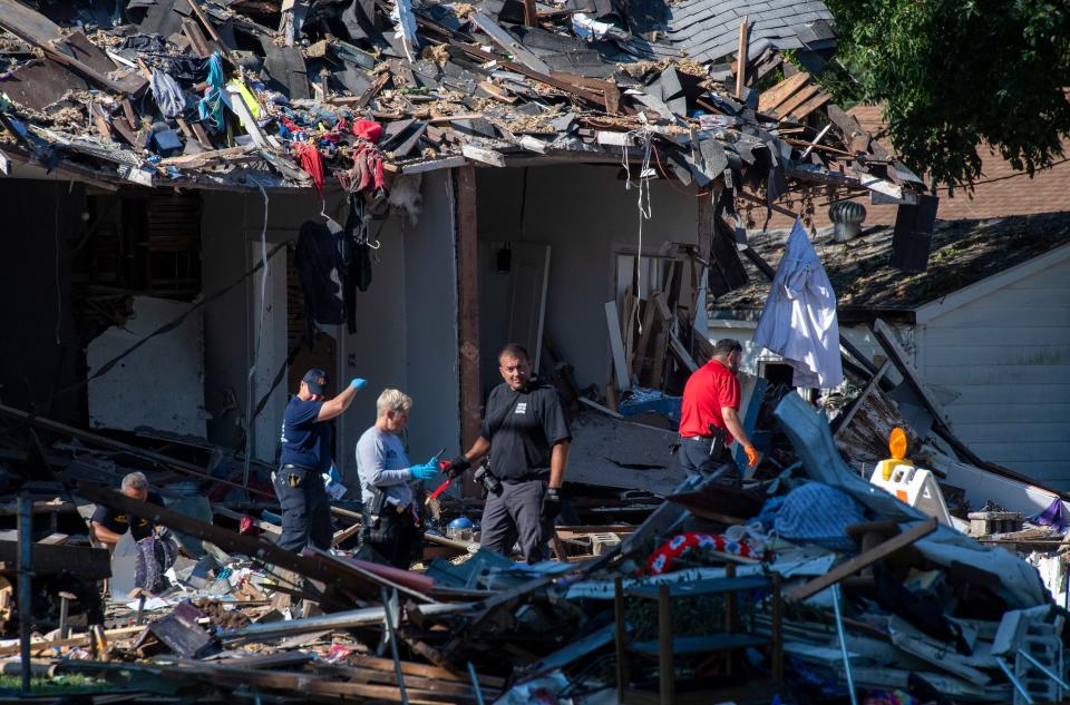 Multiple agencies work the scene the morning after a house explosion in the 1000 block of North Weinbach Avenue in Evansville, Ind., Thursday, Aug. 11, 2022. 