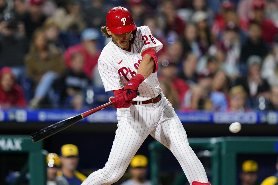 Philadelphia Phillies' Alec Bohm hits a two-run single off Milwaukee Brewers relief pitcher Brad Boxberger during the eighth inning of a baseball game, Friday, April 22, 2022, in Philadelphia. (AP Photo/Matt Slocum)