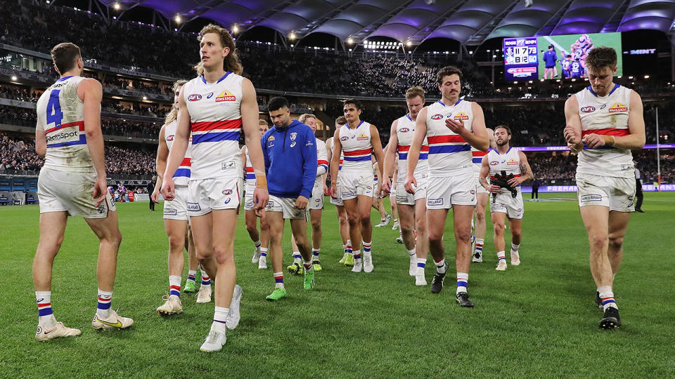 Western Bulldogs players walk off the ground after their loss to the Fremantle Dockers.