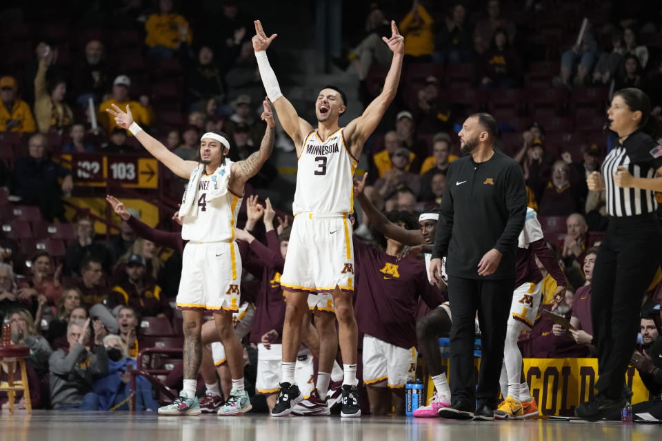 Minnesota guard Braeden Carrington (4) and forward Dawson Garcia (3) celebrate after a Minnesota basket during the second half of an NCAA college basketball game against USC Upstate, Saturday, Nov. 18, 2023, in Minneapolis. (AP Photo/Abbie Parr)